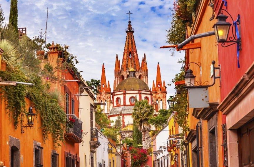 street building city urban road spire architecture tower downtown alley