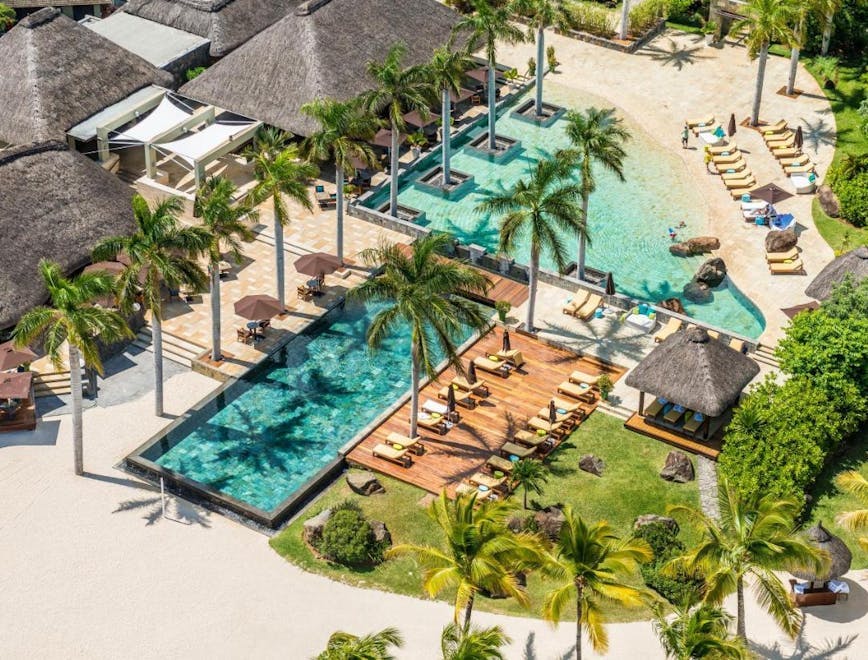 building hotel resort tree plant palm tree villa housing outdoors water