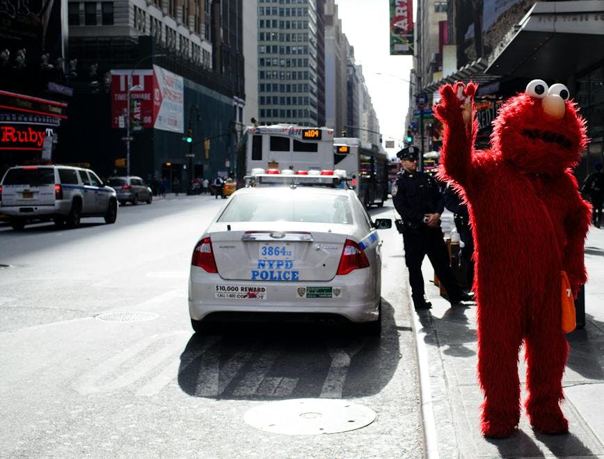 2016 elmo manhattan midtown nyc nypd new york city north america sesame street times square usa united states costumes horizontal police officers police vehicles policing sunlight tourism travel waving new york car automobile transportation vehicle person human road