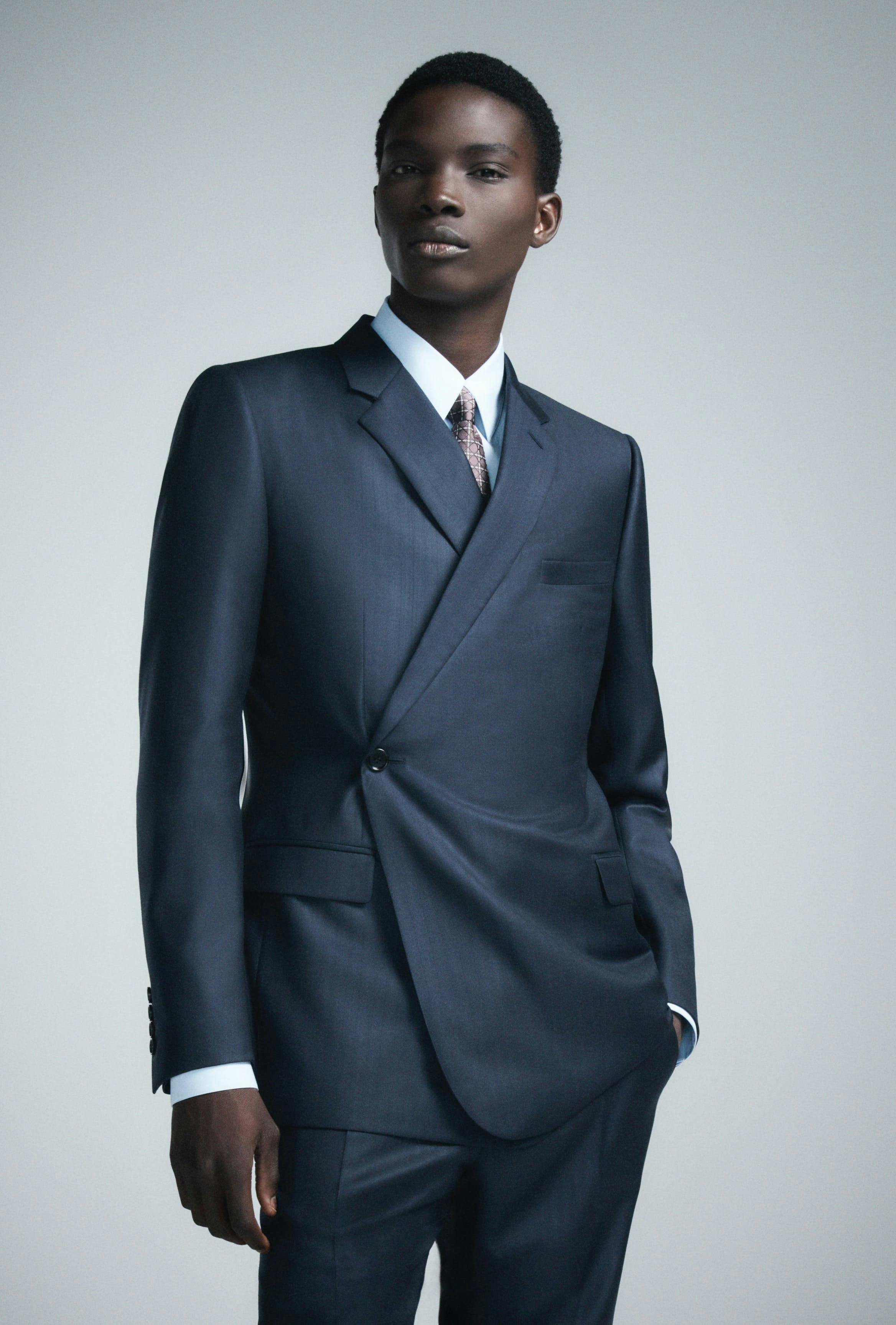 clothing formal wear suit tuxedo coat jacket blazer tie face person